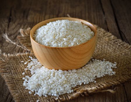 rice in  bowl on wooden surface