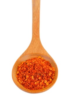 Cayenne pepper in wood spoon on white background