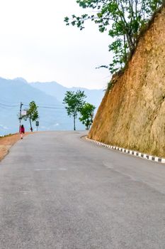 Photograph of empty road with hill in surrounding near Pokhara Lake at Kathmandu Nepal. Snap in portrait, landscape, wide screen style. Vintage film look. Vacation Freedom, Simplicity Concept.