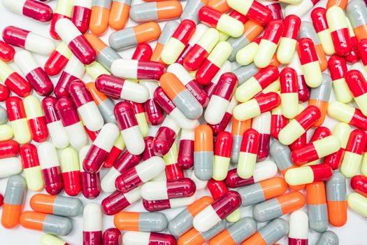 Colorful of antibiotic capsules pills on white background, antimicrobial drug resistance. Pharmaceutical industry. Pharmacy background.