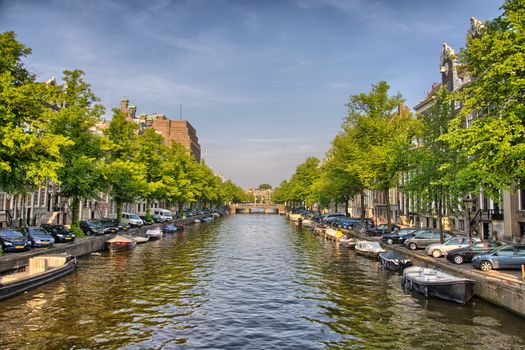 Boats on Amstel river in Amsterdam, Holland, Netherlands, HDR