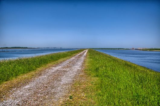 Country road surrounded by water, Holland, Netherlands, HDR
