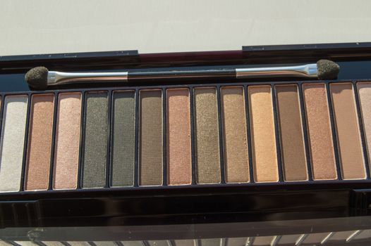 Cosmetic palette with brush and eye shadow with light brown, beige and Nude eyeshadow
