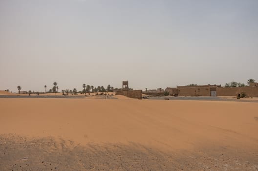 Merzouga village near sahara Erg Chebbi  dune in sand storm. Mor