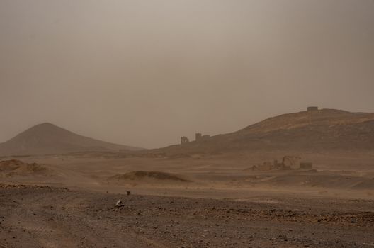 Ruined village near sahara Erg Chebbi  dune in sand storm. Moroc