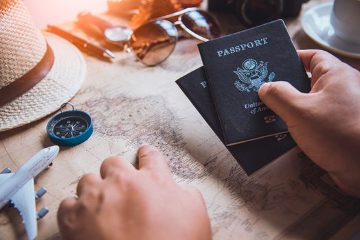 Travelers are planning a trip by searching the route on the map 