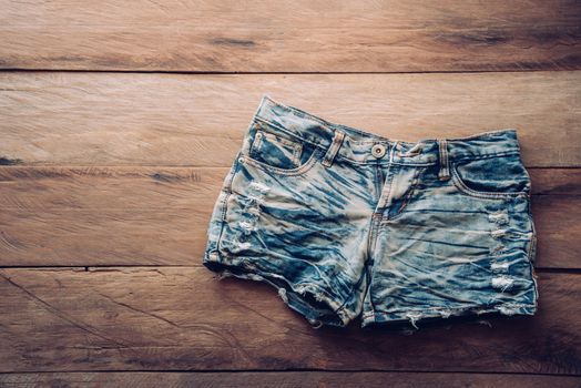Jeans shorts on the wooden floor.