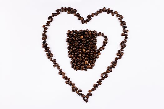 A mug and heart of coffee beans