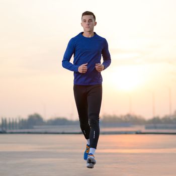 Young Sports Man Running at Sunset. Healthy Lifestyle and Sport Concept.