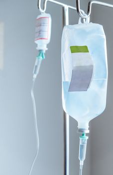 Close up of IV saline solution drip for patient in hospital