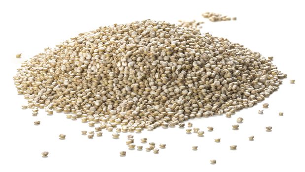 Close up photography of quinoa seeds heap over white background. Packshot style 