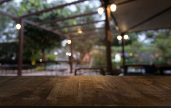 image of wooden table in front of abstract blurred background of