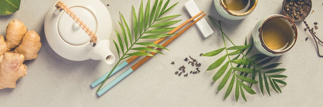 Asian food concept - tea and chopsticks on a grey concrete background