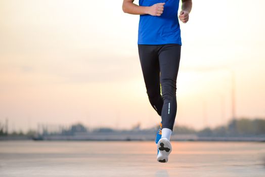 Close-up of Male Sports Mans Legs Running at Sunset. Healthy Lifestyle and Sport Concept.