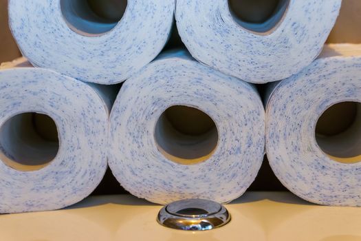 piled stack of toilet paper laying on the water closet, household products, bathroom background
