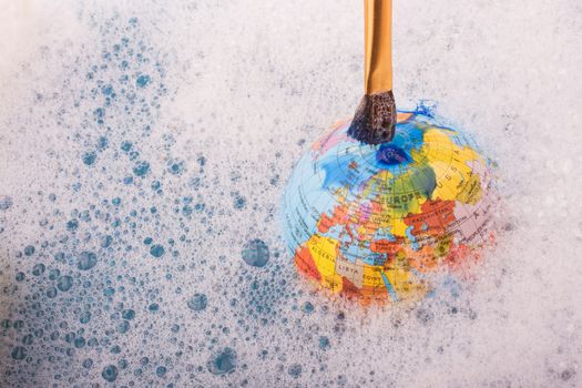 Paint dissolving on the top of globe