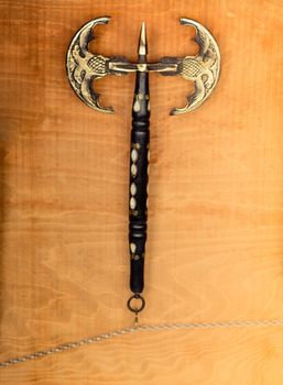 War axe and a mace on a wooden background