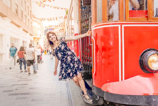 Beautiful woman in red dress stands at Istiklal street