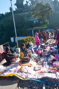 Batasia Loop, Darjeeling, 2 Jan 2019: Shopkeepers with their little makeshift stalls on the railway lines, wrap up their business with great agility and speed as the toy train arrives.