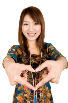 Asian woman hand forming a heart shape