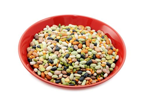 Mixed dried beans and peas in a red bowl