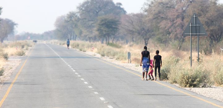People walking at the side of the road