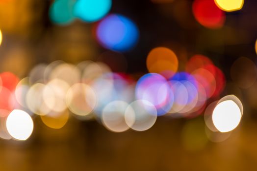 Colorful blurred car headlights and flashing traffic lights 