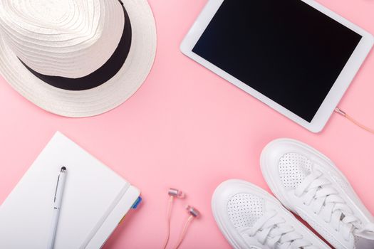 Fashion blogger traveler concept minimal set of feminine accessories on pink trendy background