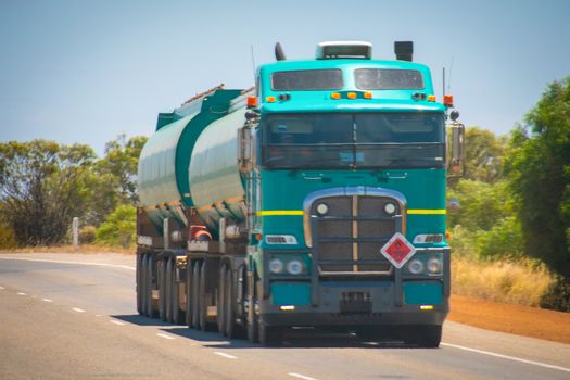 Long Road Train in the Australian Outback with trailer bringing fuel to gas station