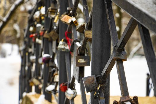 Close-up of padlocks on bridge railing. love locks