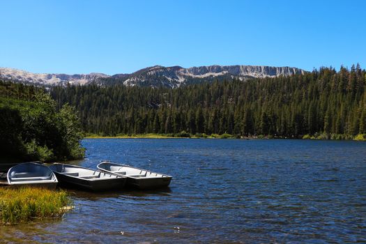 fishing boat docked in a calm lake of dreamy scenery