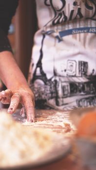 Close up scene of female hands making dough