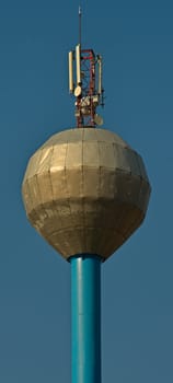 Water tower with antennas on top of it