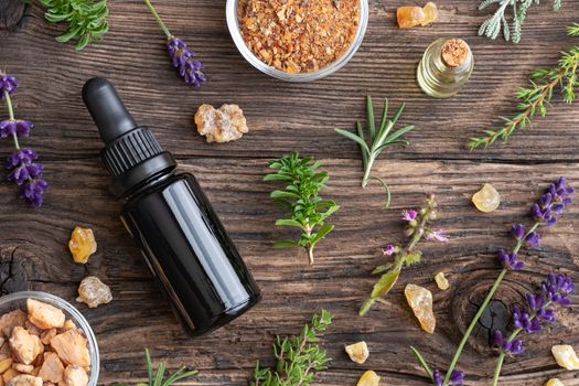 Bottles of essential oil with frankincense, tulsi, mountain savo