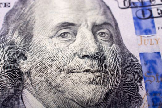 Close up of Benjamin Franklin face on US dollar 