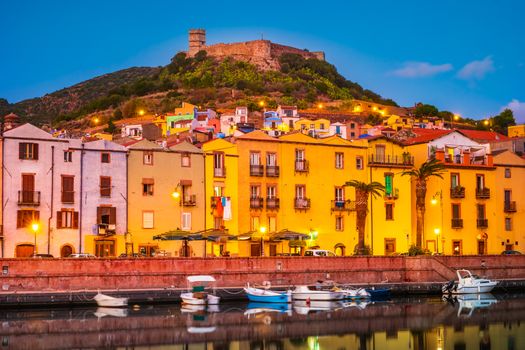 View of the colorful houses and castle in the background in the city of Bosa, Sardinia, Italy.
