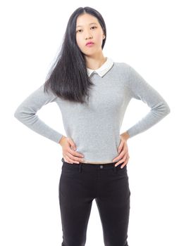 Teenage Asian high school girl hands on hips, three quarter