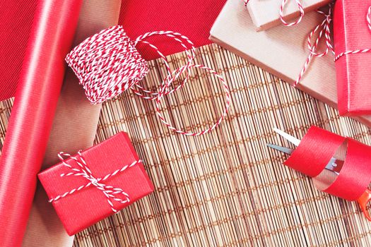 Preparing for the holiday - gift wrapping in red and beige wrapping paper