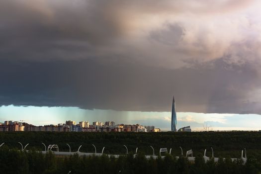 huge thundercloud on the outskirts of the city before the rain - image