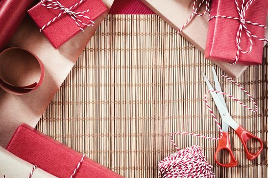 Preparing for the holiday - gift wrapping in red and beige wrapping paper
