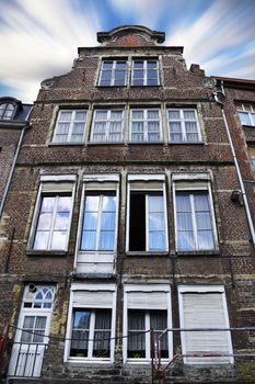 Old house building in Belgium from the outside with blue sky