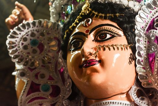 Close up of Goddess Maa Durga Idol. A symbol of strength and power. Portrait was taken during Durga Puja celebrations from a famous potter studio in Kumartuli, Calcutta Kolkata, West Bengal, India