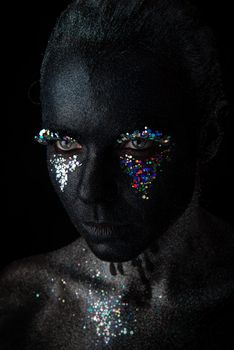 Girl in black makeup with sparkles