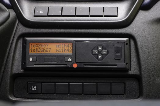 Digital tachograph display shows the 11 hour day break. Starting new shift. No personal data. Tachograph in a van