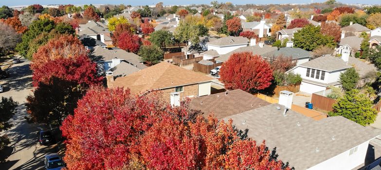 Panoramic aerial close-up colorful houses during fall season in residential area near Dallas
