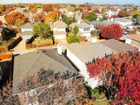 Aerial close-up colorful houses during fall season in residential area near Dallas