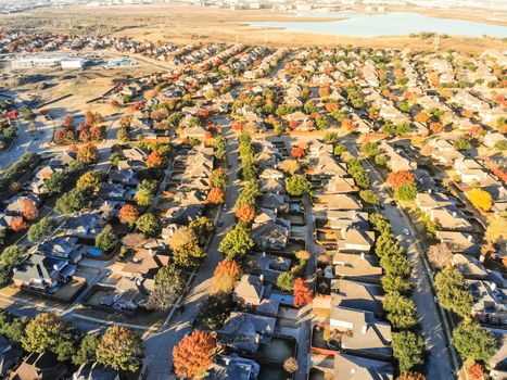 Top view lakeside residential subdivision houses with colorful autumn leaves near Dallas, Texas