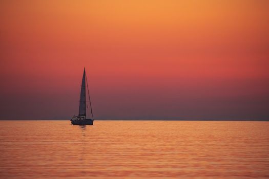 Sail boat over sunset
