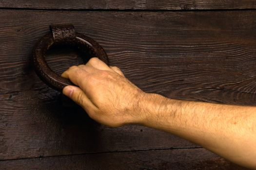 hand of a man knocking at the door