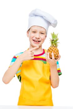 little cook in a cap with a mini pineapple on a white background in an apron